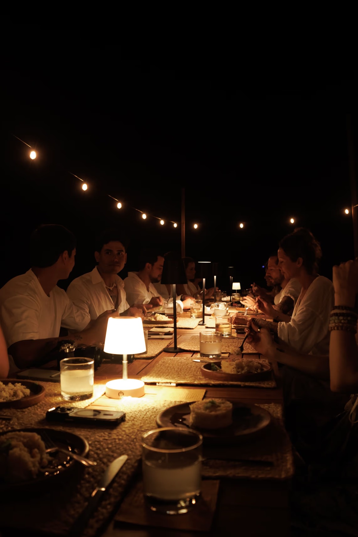 A candlelit dinner table at night